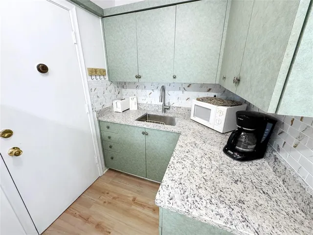 a kitchen with a refrigerator and a stove