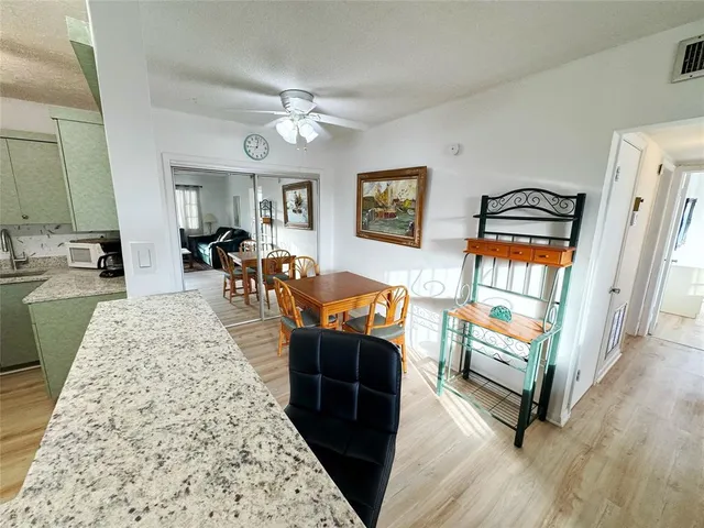 a living room with granite countertop furniture and a wooden floor