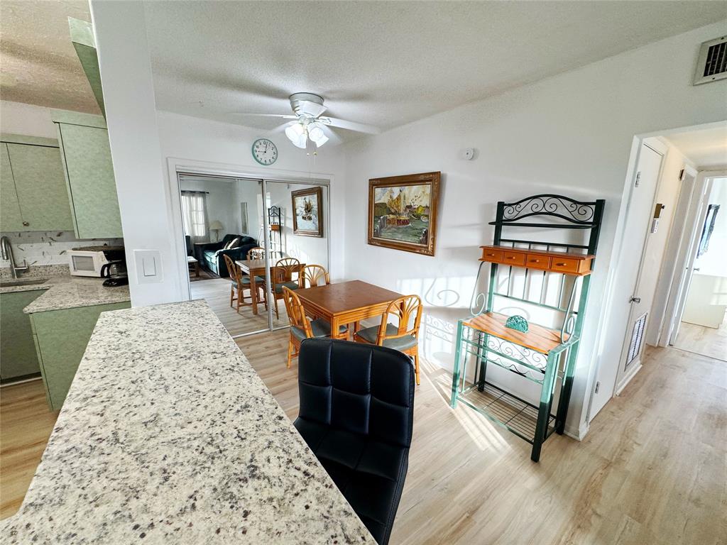 310 South Cypress Road, Unit 729 Pompano Beach, FL 33060 - Photo 8 of 30 a living room with furniture and a wooden floor