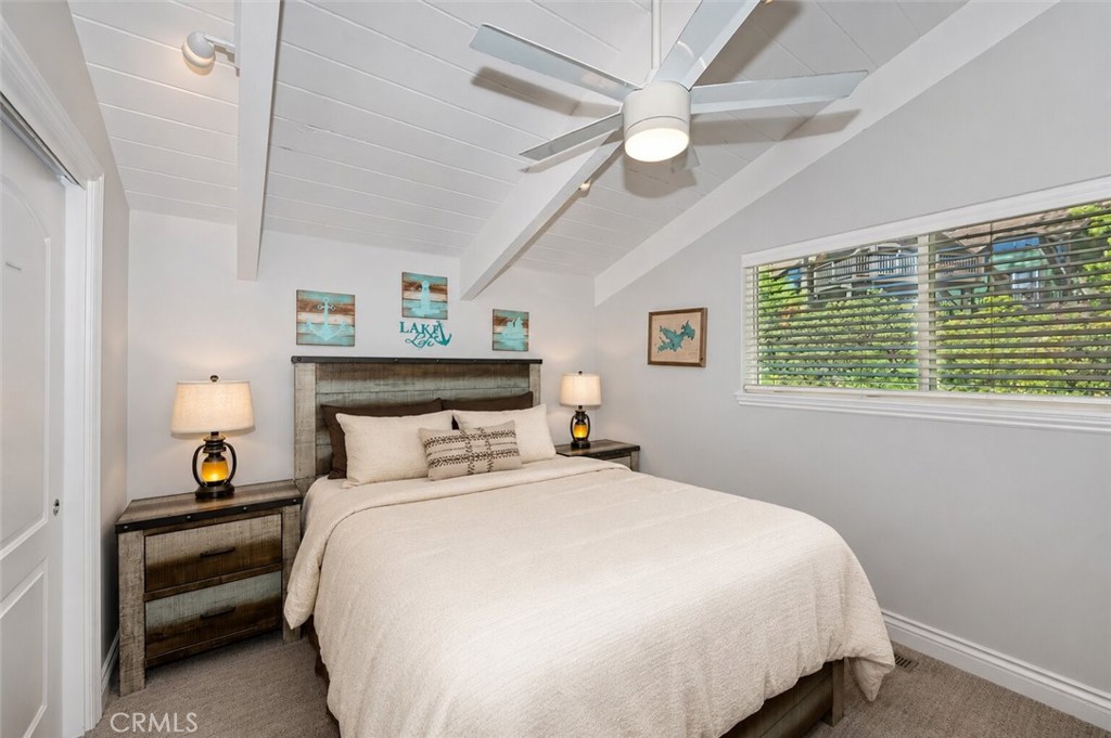 27550 North Bay Road Lake Arrowhead, CA 92352 - Photo 21 of 32 a bedroom with a bed and a large window
