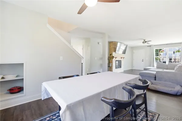 a dining room with furniture entryway and wooden floor