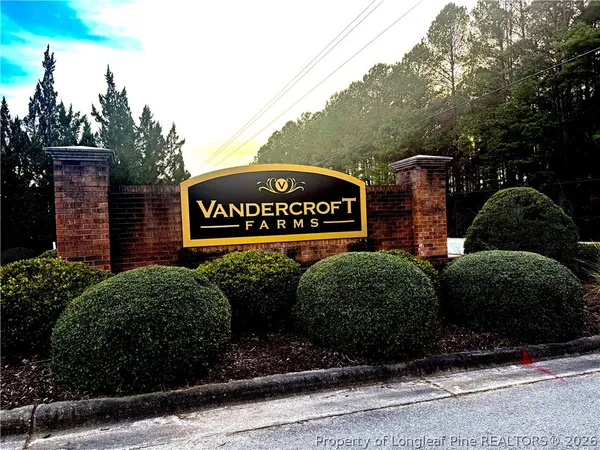 a view of a house with a backyard and tree