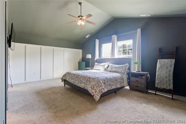 a bedroom with a bed and a television