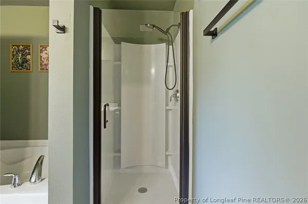a bathroom with a double vanity sink a mirror and bathtub