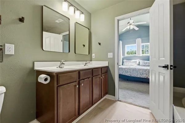 a en suite bathroom with a tub shower and bedroom