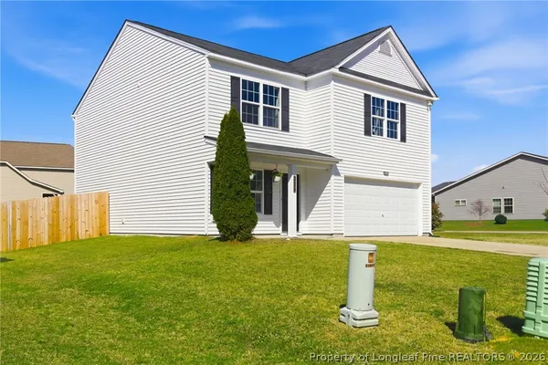 a view of a house with a backyard
