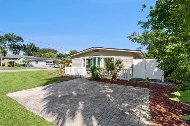an aerial view of a house with a swimming pool outdoor seating and yard