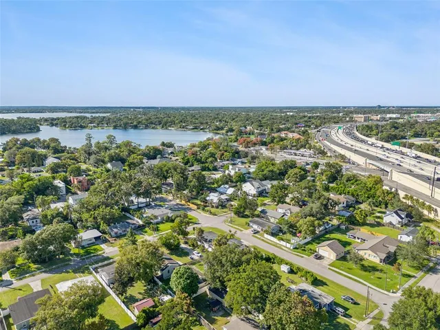 an aerial view of a houses with a lake