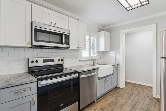 a kitchen with a stove microwave and sink