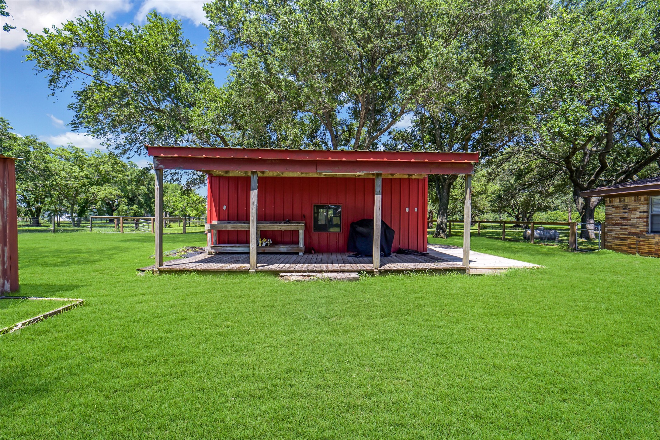 9606 Needville Fairchilds Road Needville, TX 77461 - Photo 41 of 46 a view of a house with a backyard and a patio