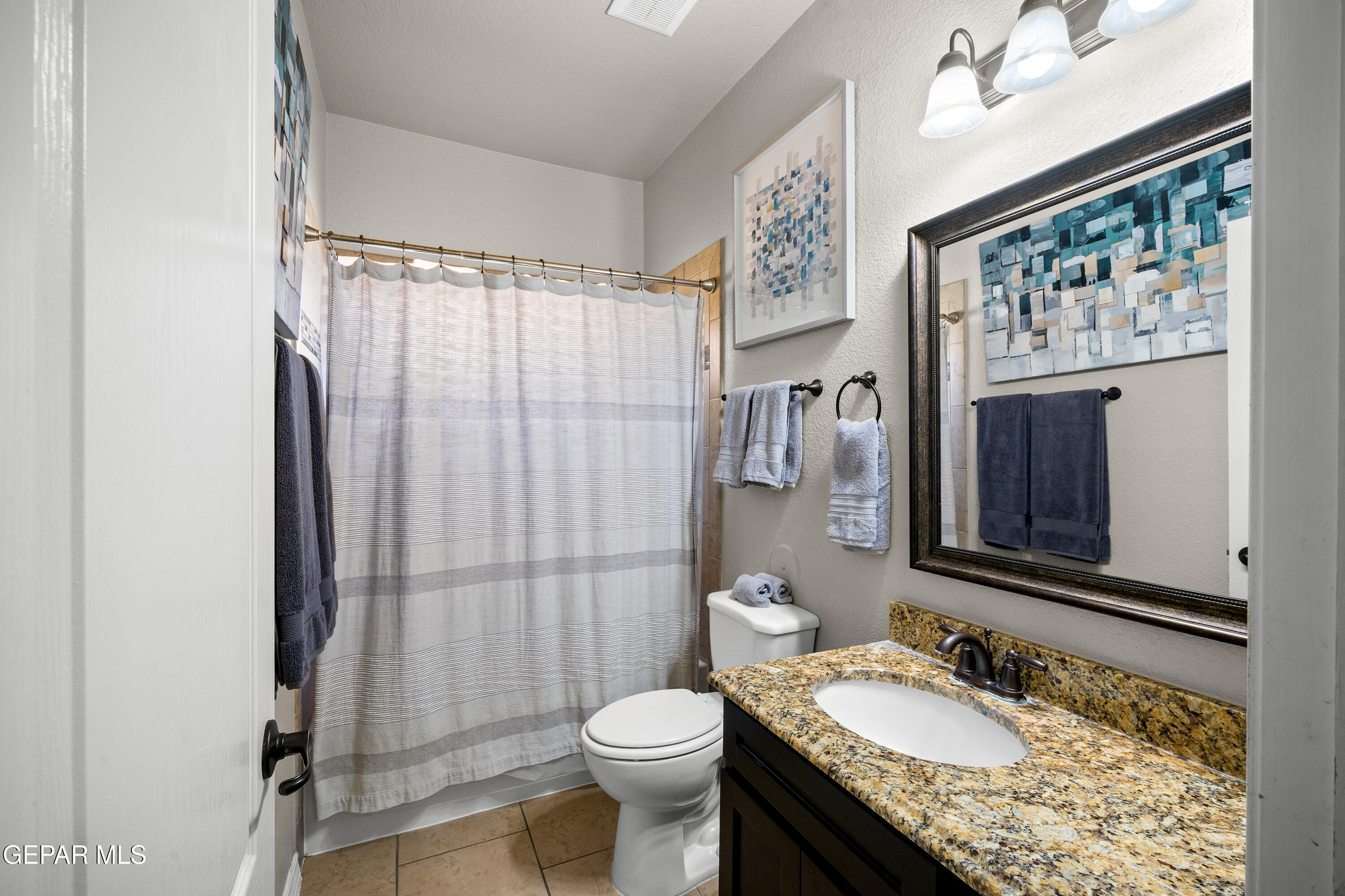 7755 Enchanted Path Drive El Paso, TX 79911 - Photo 19 of 34 a bathroom with a granite countertop toilet sink and mirror