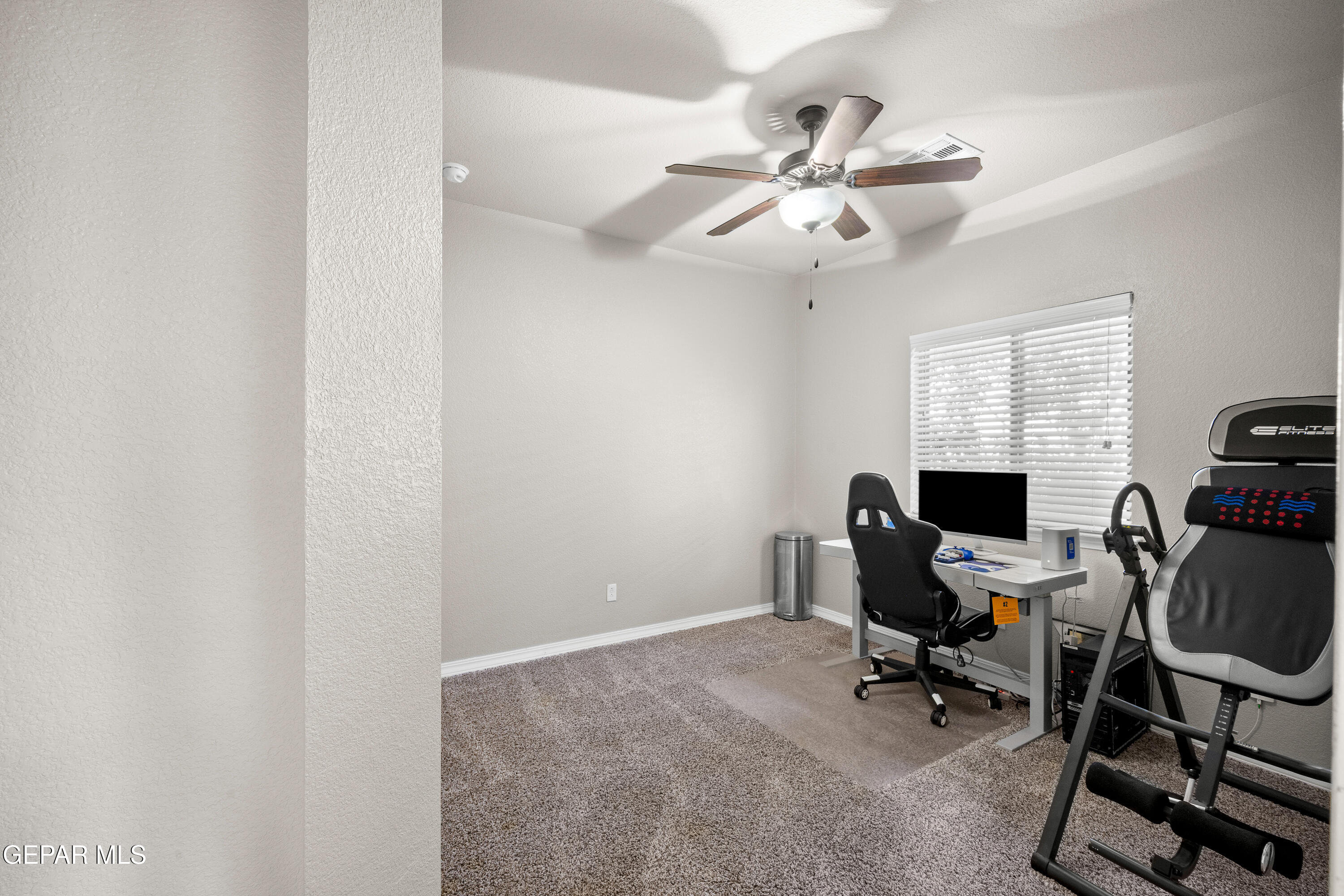 7755 Enchanted Path Drive El Paso, TX 79911 - Photo 20 of 34 a view of a workspace with furniture and a window