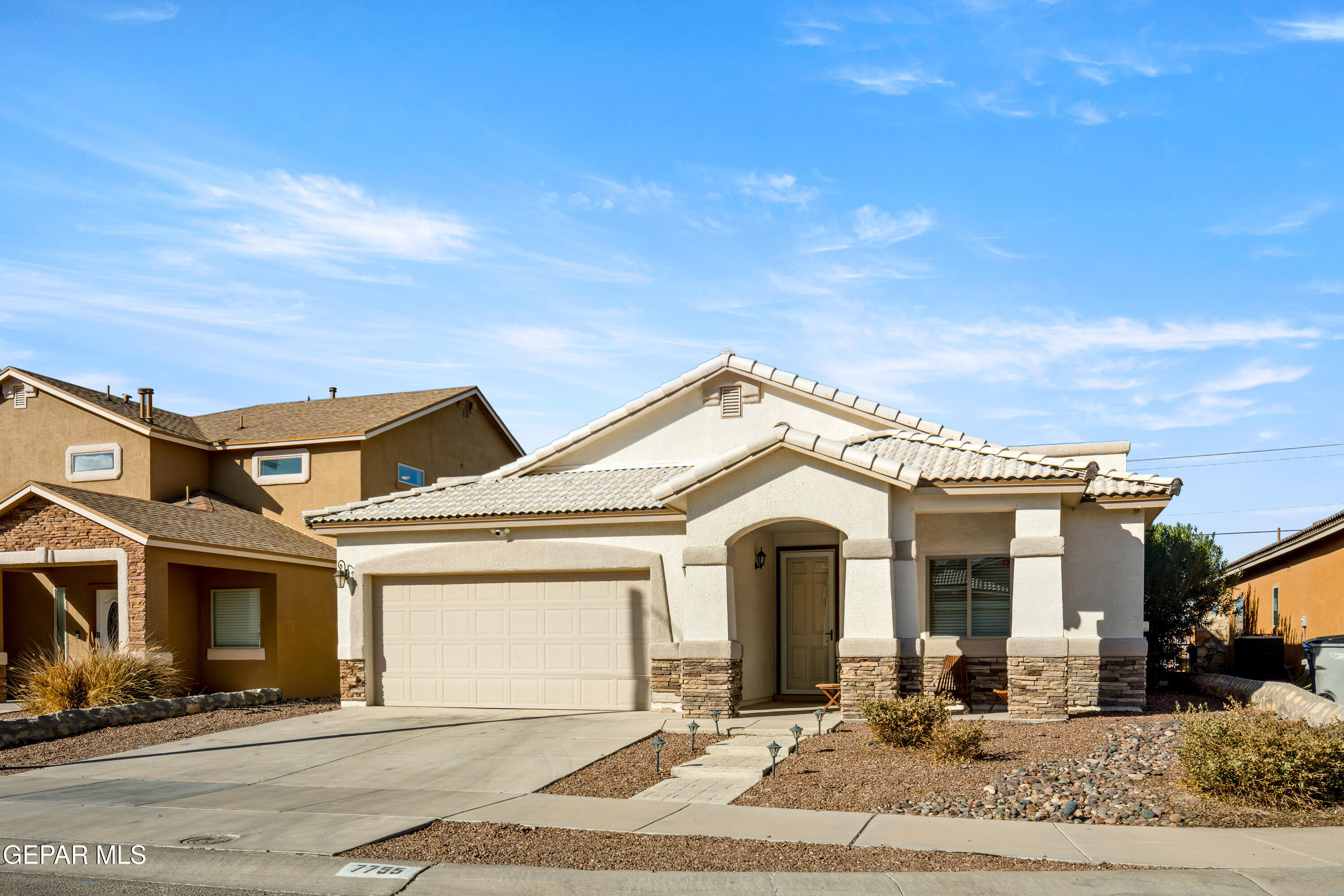 7755 Enchanted Path Drive El Paso, TX 79911 - Photo 2 of 34 a view of a white house with large windows and palm tree