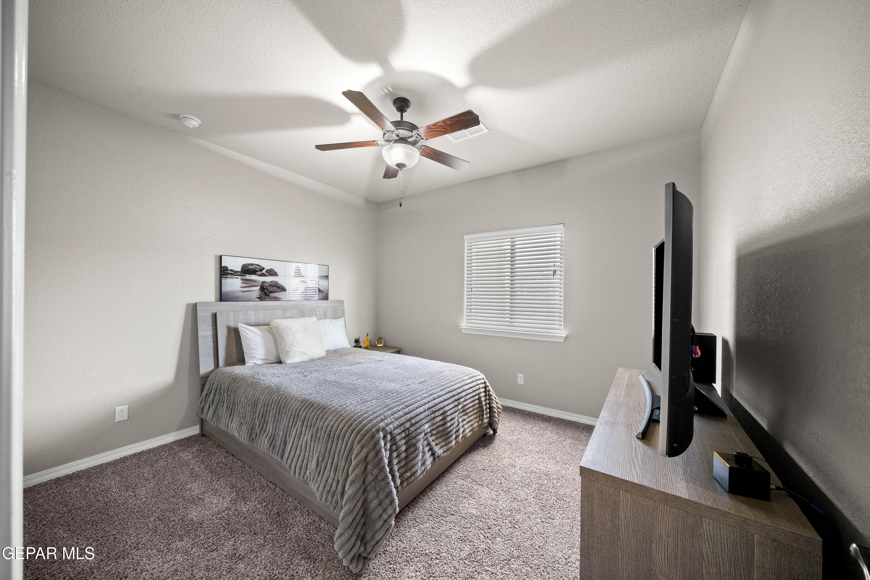 7755 Enchanted Path Drive El Paso, TX 79911 - Photo 22 of 34 a bedroom with a bed and a flat screen tv