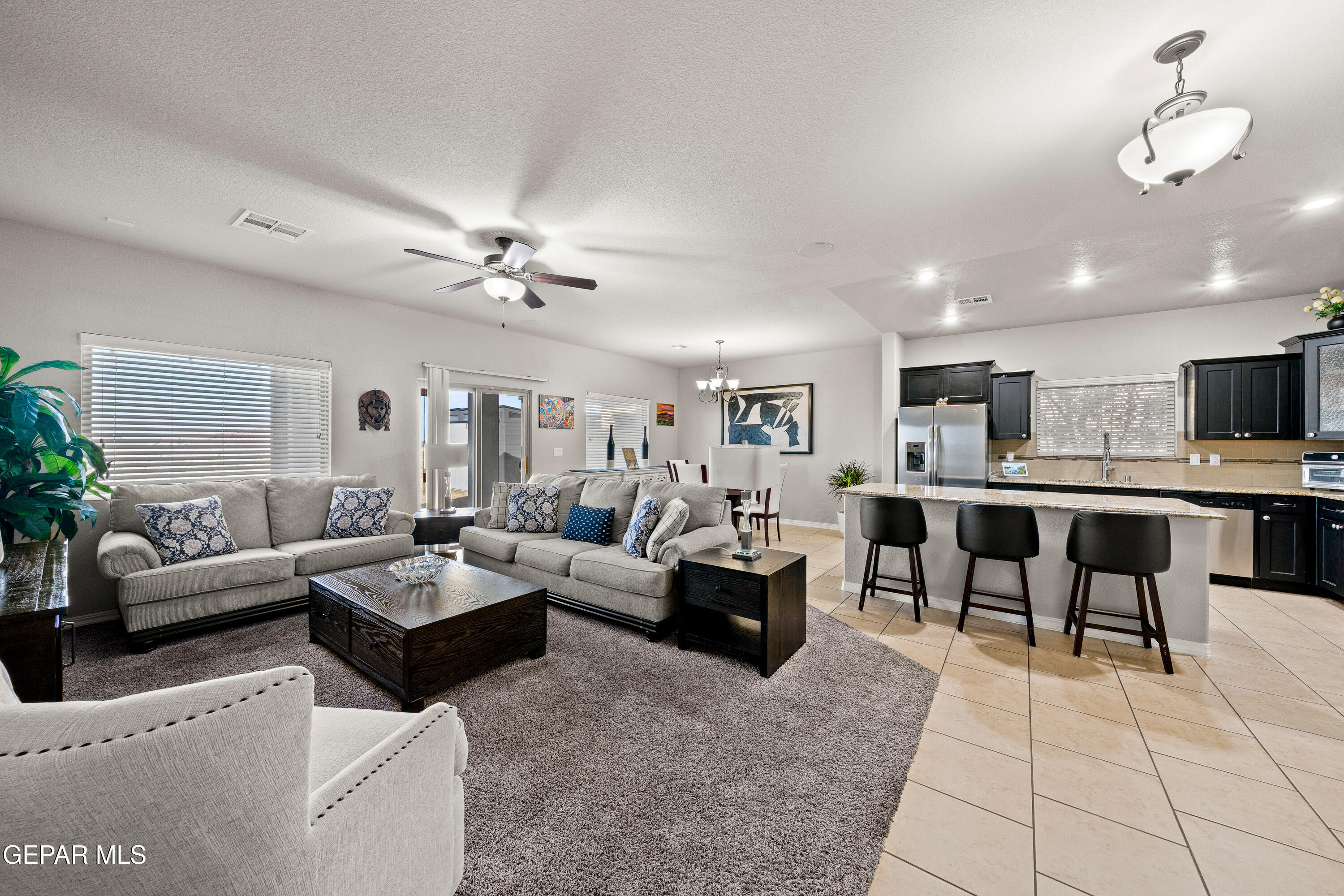 7755 Enchanted Path Drive El Paso, TX 79911 - Photo 3 of 34 a living room with furniture kitchen view and a chandelier