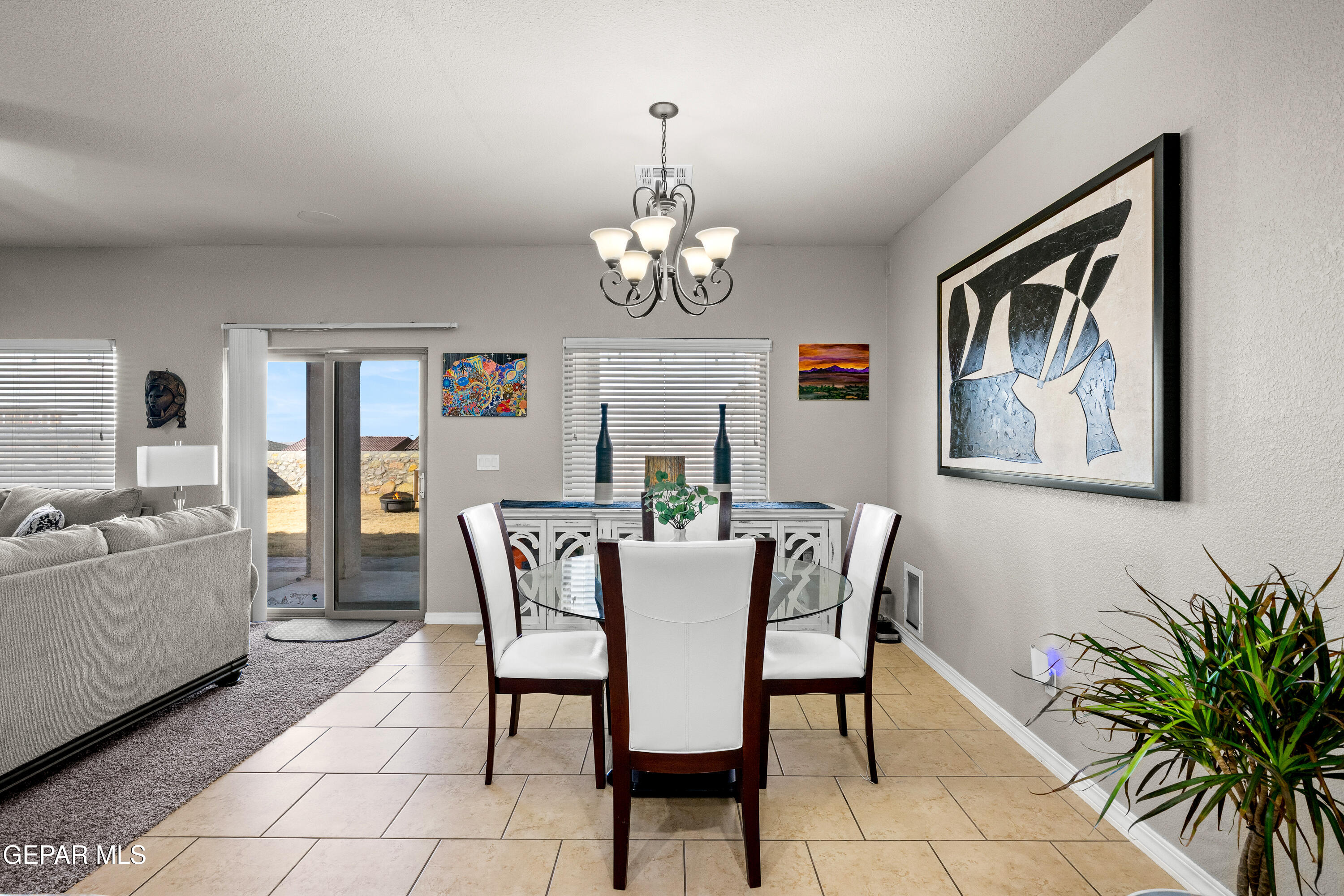 7755 Enchanted Path Drive El Paso, TX 79911 - Photo 6 of 34 a dining room with furniture a chandelier and window