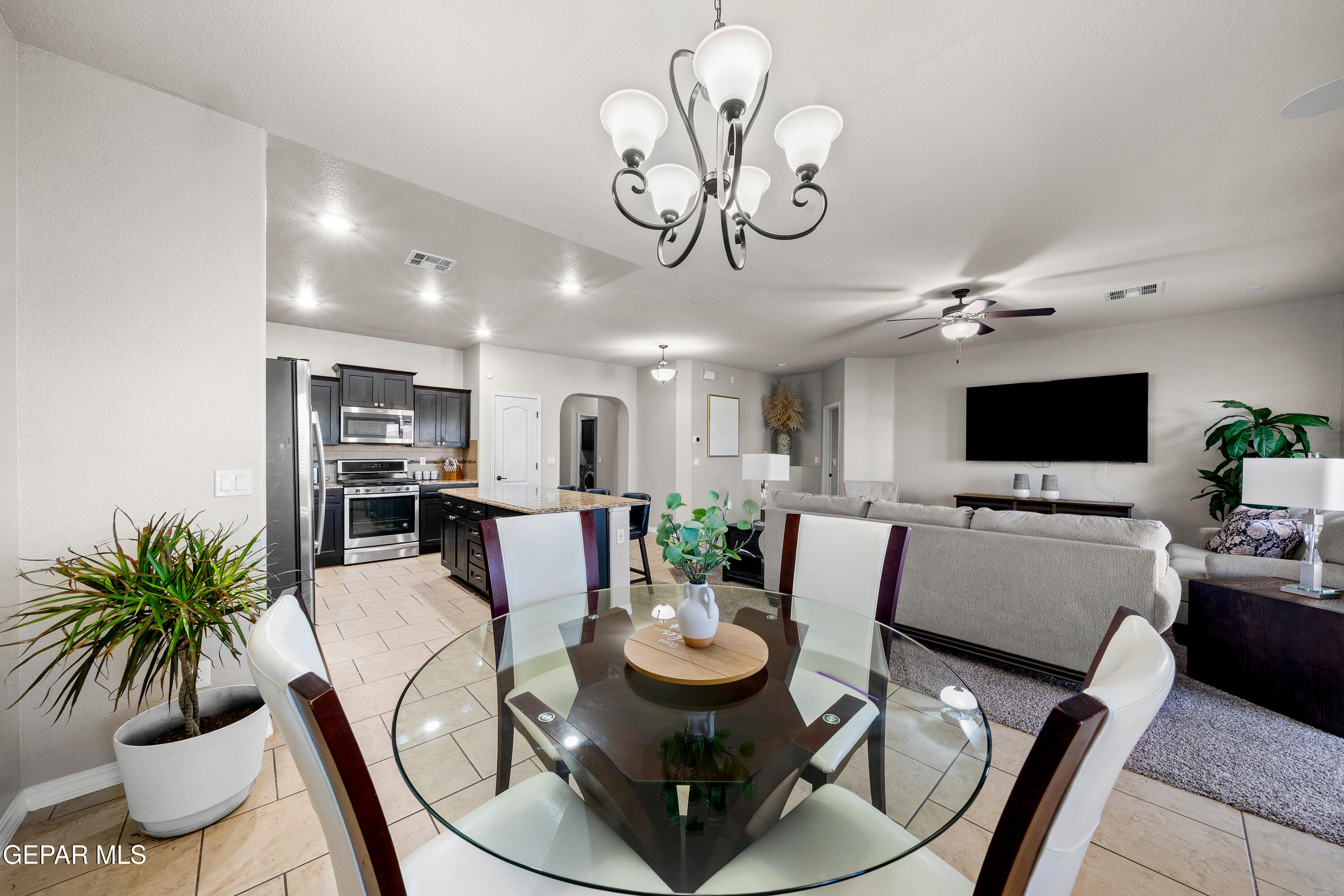 7755 Enchanted Path Drive El Paso, TX 79911 - Photo 8 of 34 a view of a dining room with furniture and a flat screen tv