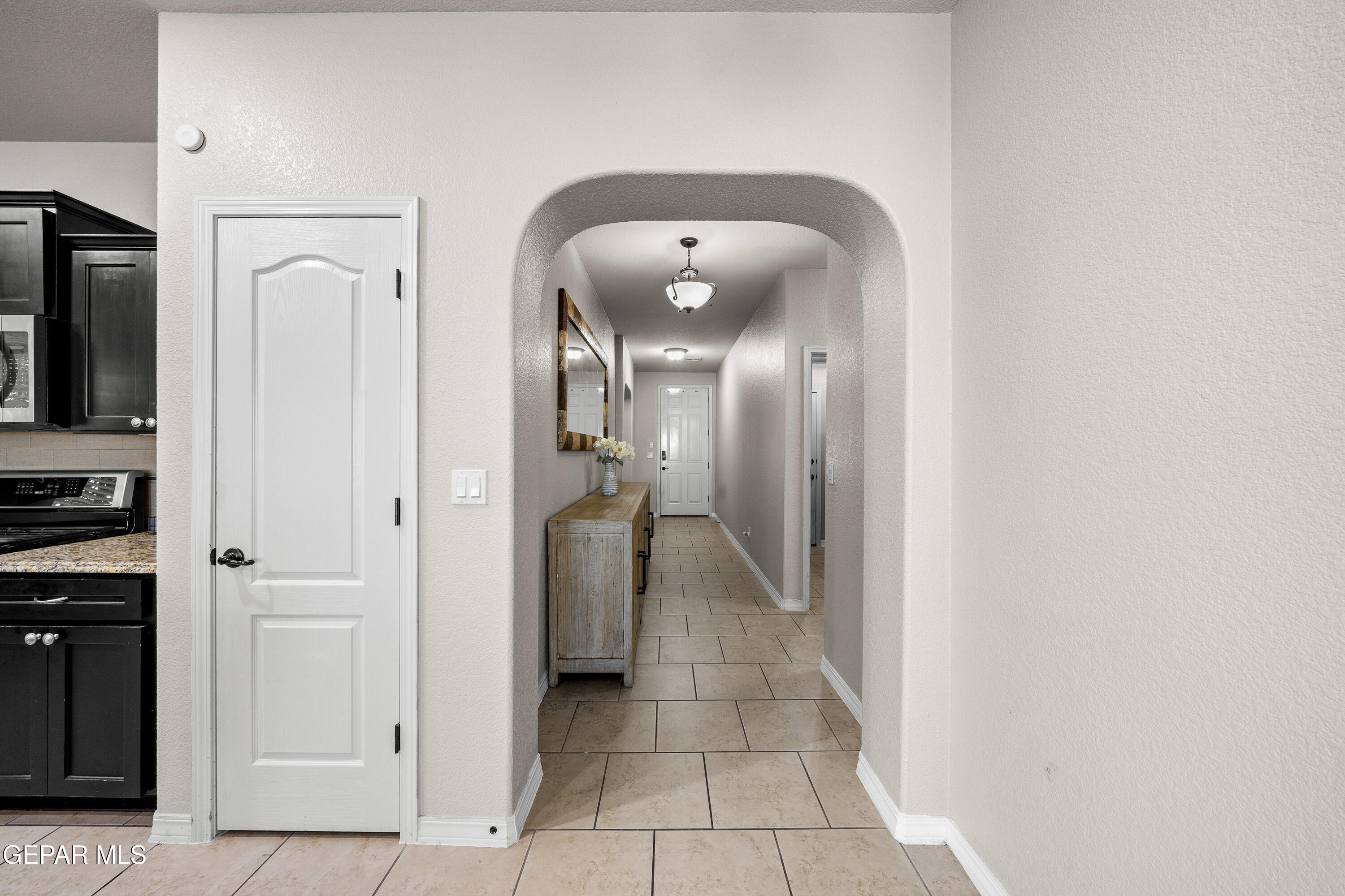 7755 Enchanted Path Drive El Paso, TX 79911 - Photo 9 of 34 a view of a hallway with closet and a fireplace