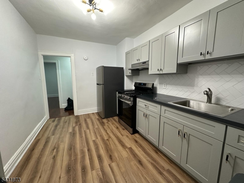32 Hamilton Avenue, Unit 2 Fairview, NJ 07022 - Photo 8 of 30 a kitchen with cabinets appliances and a window