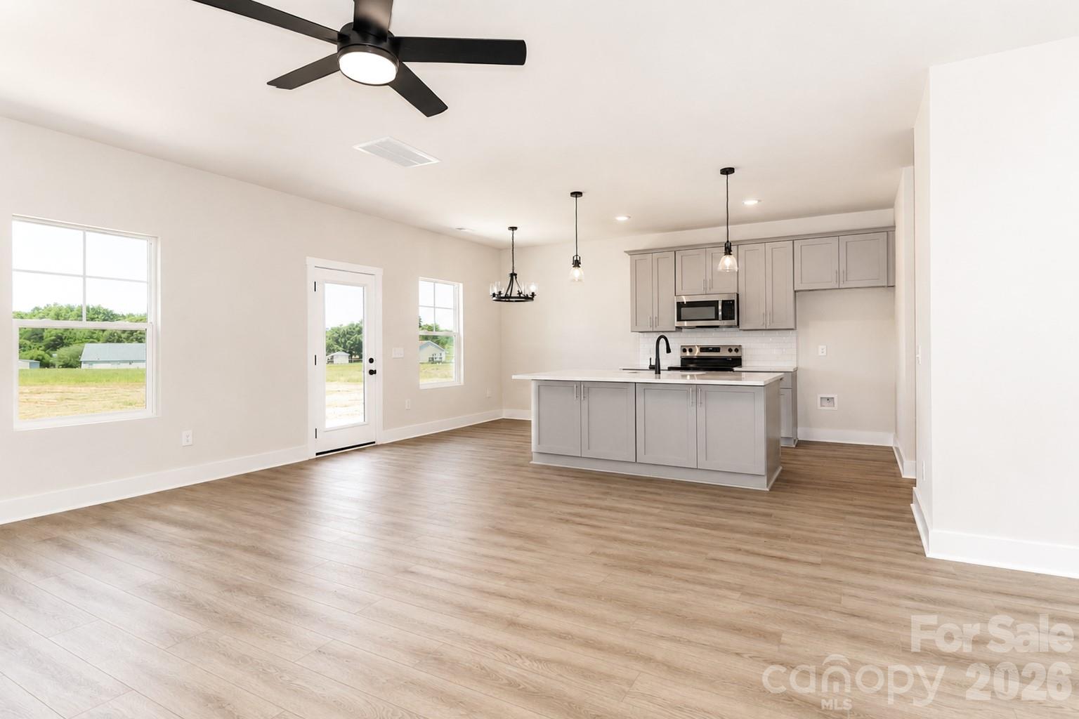 237 3rd Creek Road Stony Point, NC 28678 - Photo 8 of 29 a view of an empty room with kitchen and window