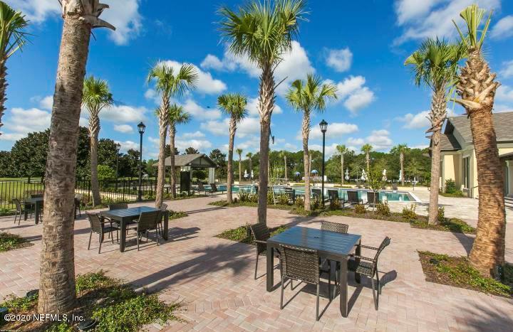 2133 West Quay Road St. Augustine, FL 32092 - Photo 4 of 12 a view of a patio with a table and chairs