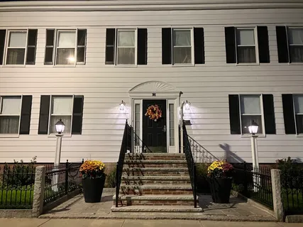 a view of a brick house with many windows