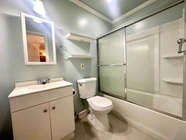 a bathroom with a sink toilet and shower