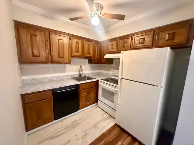 a kitchen with a refrigerator sink and cabinets