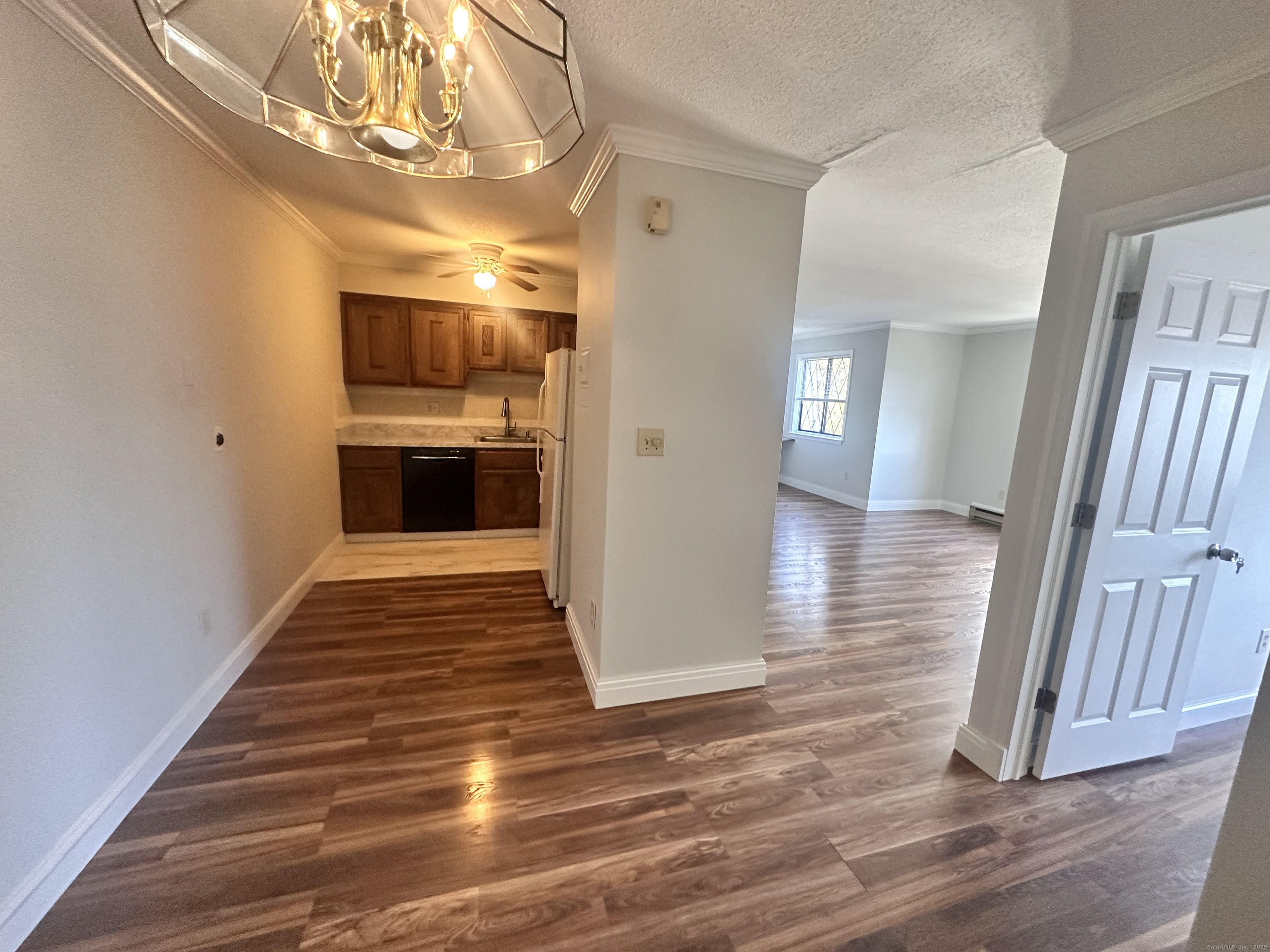 150 Main Street, Unit B6 Norwalk, CT 06851 - Photo 4 of 15 a view of a hallway with wooden floor and a kitchen space