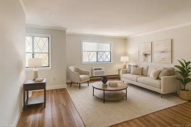 a living room with furniture a rug and a window