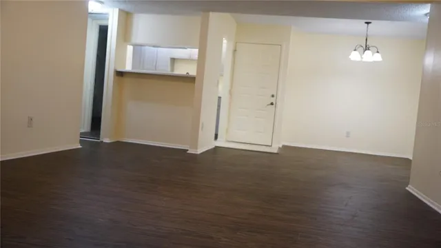 an empty room with wooden floor