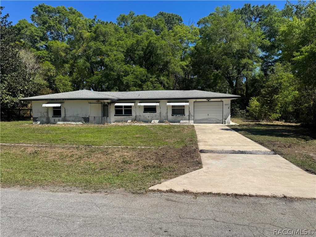 3953 South Fernpark Terrace Inverness, FL 34452 - Photo 1 of 16 a view of house with yard and trees in the background