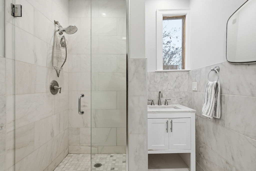 80 Marion Street, Unit 2 Boston, MA 02128 - Photo 15 of 33 a bathroom with a sink a toilet and shower
