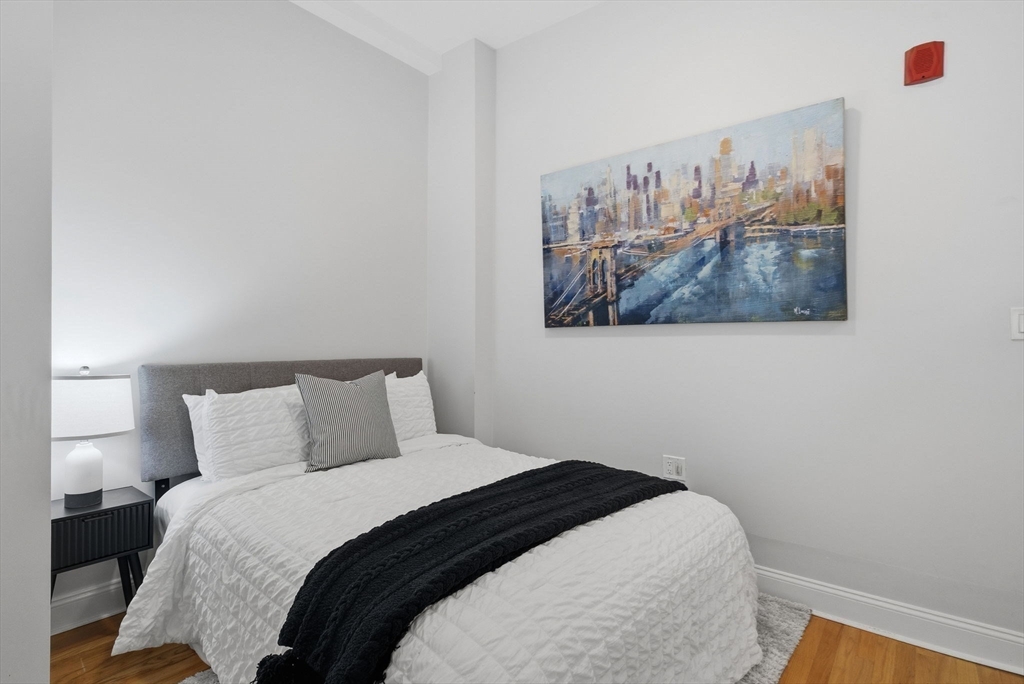80 Marion Street, Unit 2 Boston, MA 02128 - Photo 17 of 33 a bedroom with a bed and painting on the wall