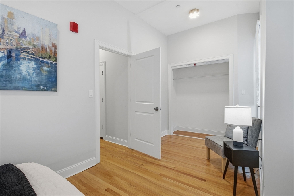 80 Marion Street, Unit 2 Boston, MA 02128 - Photo 18 of 33 a bedroom with a bed and a table