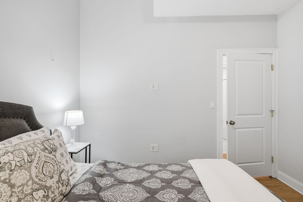 80 Marion Street, Unit 2 Boston, MA 02128 - Photo 21 of 33 a bedroom with a bed and a lamp