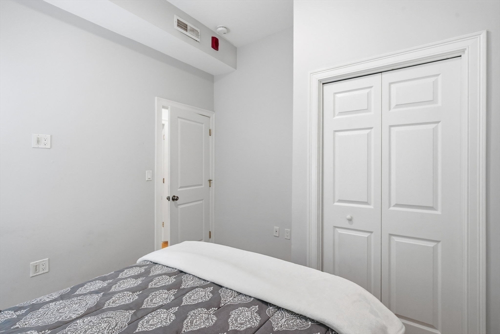 80 Marion Street, Unit 2 Boston, MA 02128 - Photo 21 of 33 a bedroom with a bed and hallway
