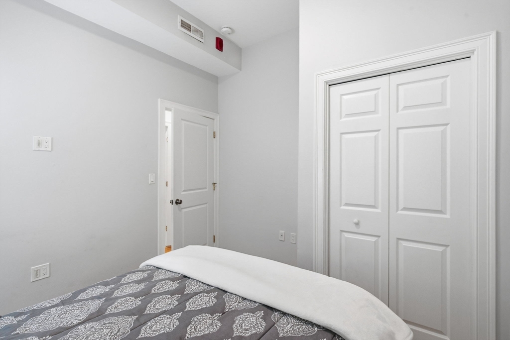 80 Marion Street, Unit 2 Boston, MA 02128 - Photo 22 of 33 a bedroom with a bed and hallway