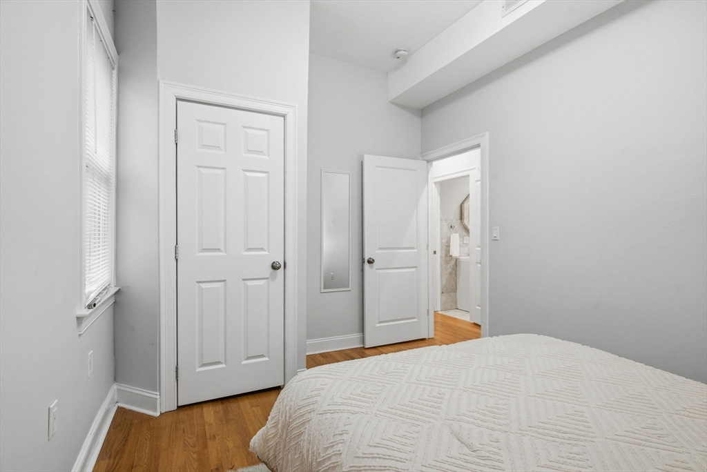 80 Marion Street, Unit 2 Boston, MA 02128 - Photo 24 of 33 a bedroom with a bed and wooden floor