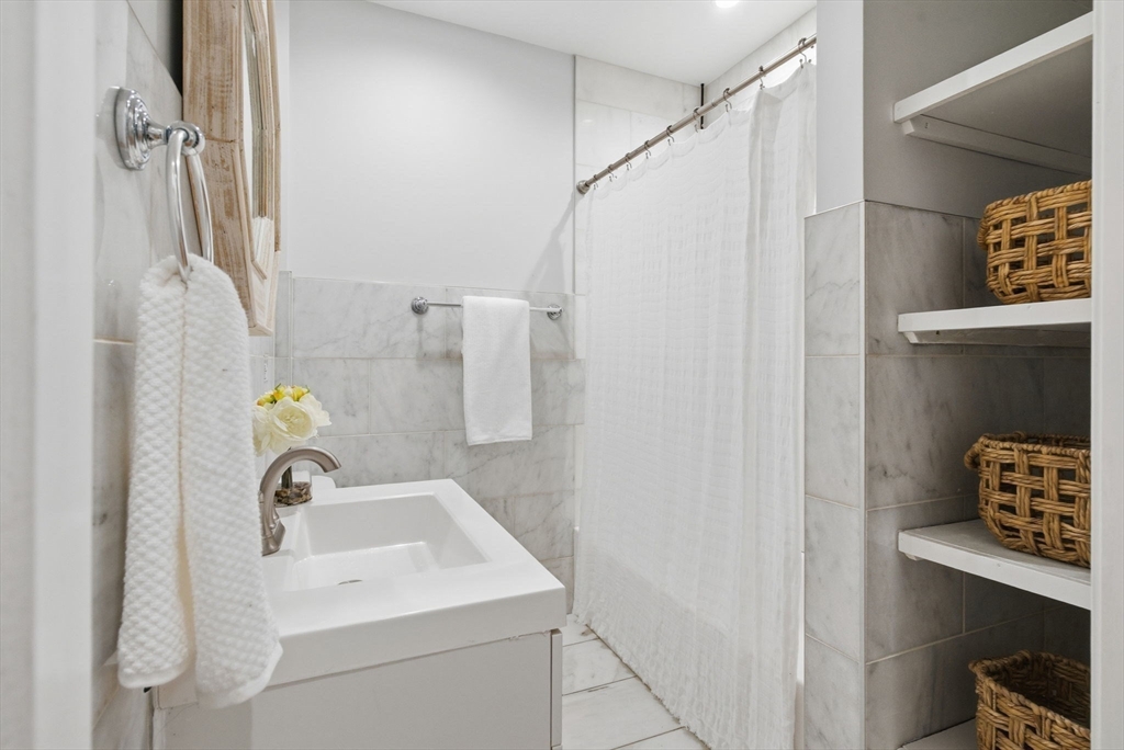80 Marion Street, Unit 2 Boston, MA 02128 - Photo 27 of 33 a bathroom with a sink and a vanity