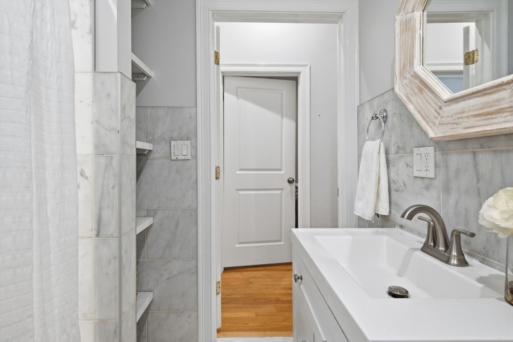 80 Marion Street, Unit 2 Boston, MA 02128 - Photo 28 of 33 a bathroom with a sink a mirror and a shower