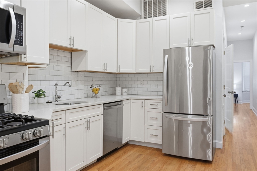 80 Marion Street, Unit 2 Boston, MA 02128 - Photo 5 of 33 a kitchen with appliances a sink and a refrigerator