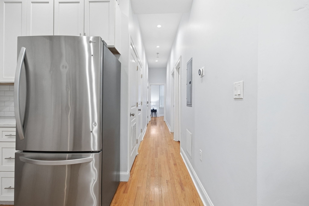 80 Marion Street, Unit 2 Boston, MA 02128 - Photo 6 of 33 a view of hallway with cabinets and wooden floor