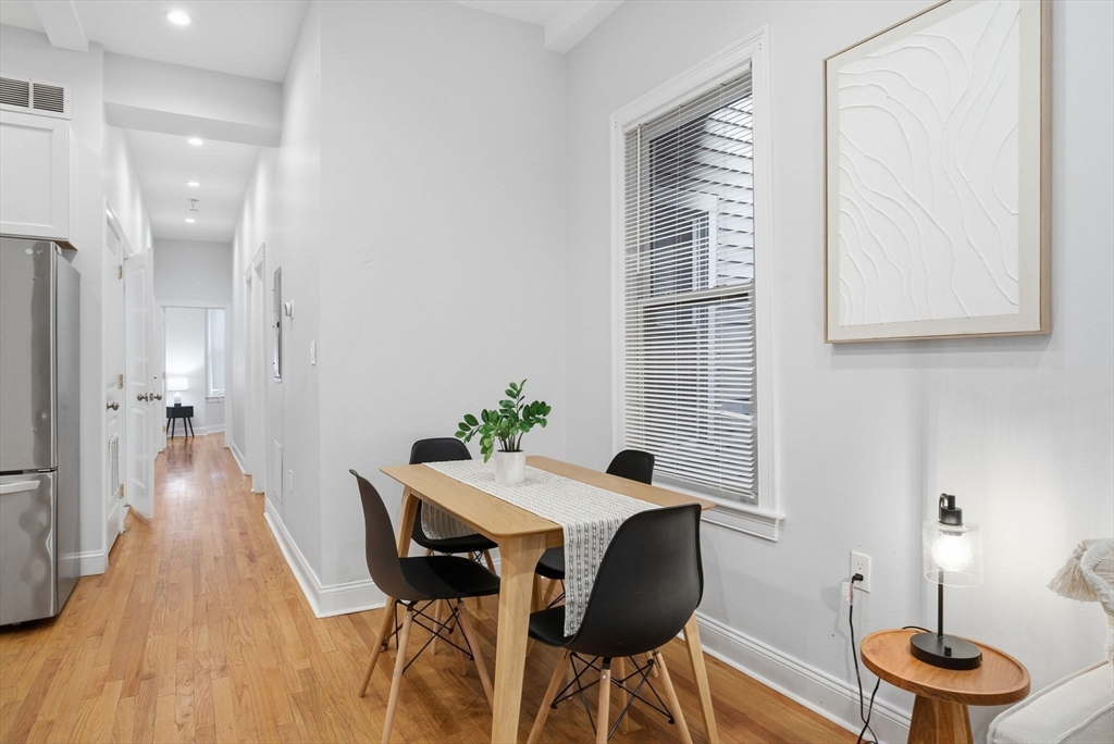 80 Marion Street, Unit 2 Boston, MA 02128 - Photo 9 of 33 a view of a dining room with furniture and wooden floor