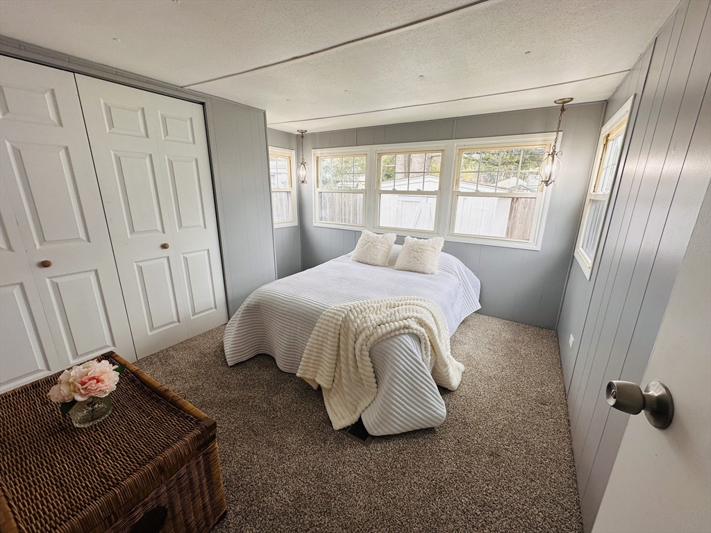 70 Shumway Street, Unit A3 Springfield, MA 01119 - Photo 18 of 28 a bedroom with a bed and wooden floor