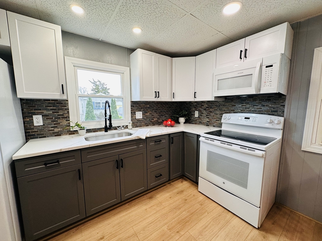 70 Shumway Street, Unit A3 Springfield, MA 01119 - Photo 5 of 28 a kitchen with granite countertop a sink a stove and cabinets