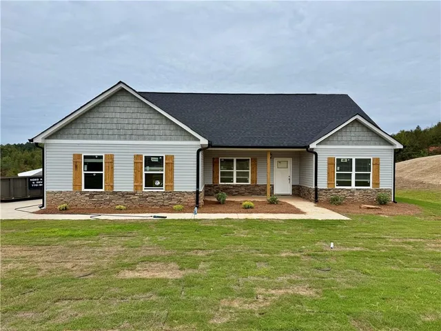 a front view of house with yard and green space