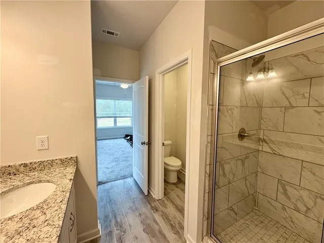 a bathroom with a tub shower and vanity