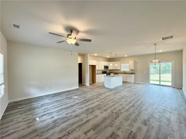 a view of an empty room with a kitchen