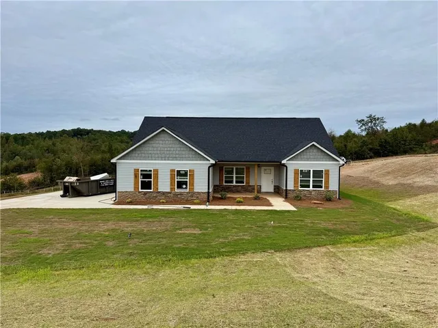 a house with a big yard and large trees